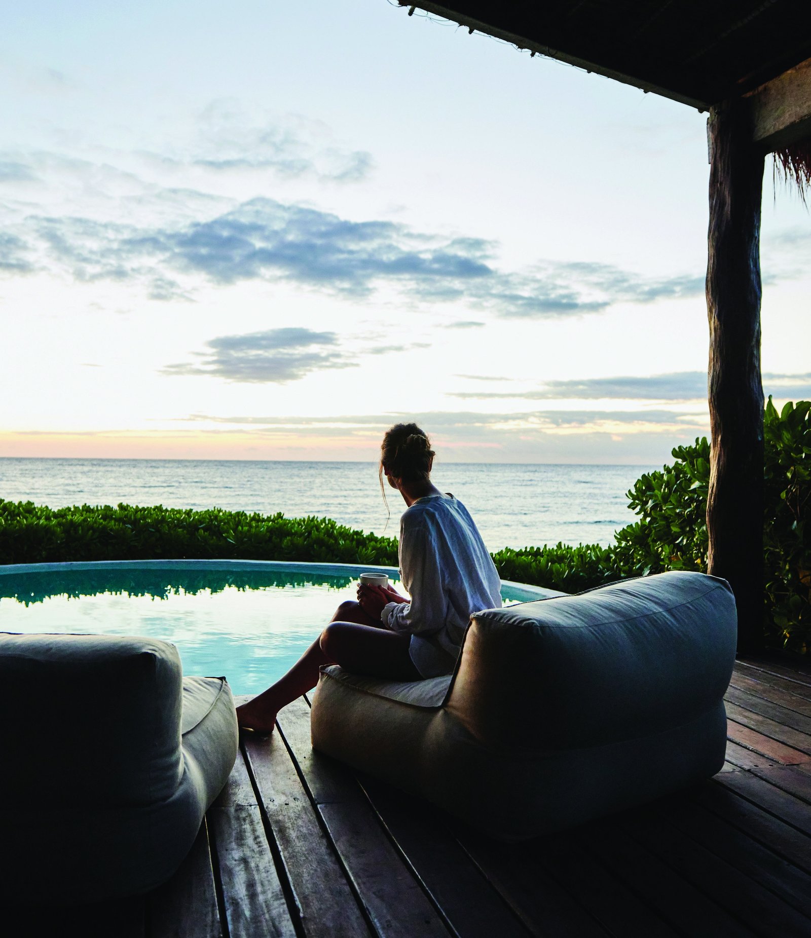 A quiet morning with coffee beside a coastal pool